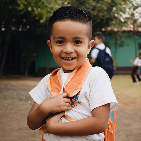 boy with orange backpack on